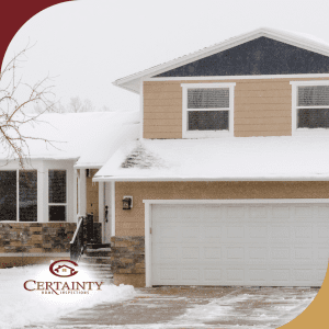 Two-story beige home with snow-covered surroundings