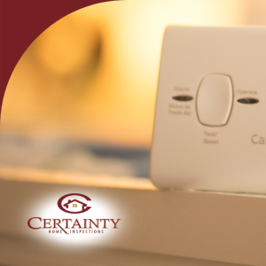 Carbon monoxide alarm placed on a surface with warm lighting