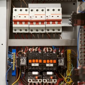 Open electrical panel with wiring and circuit breakers.