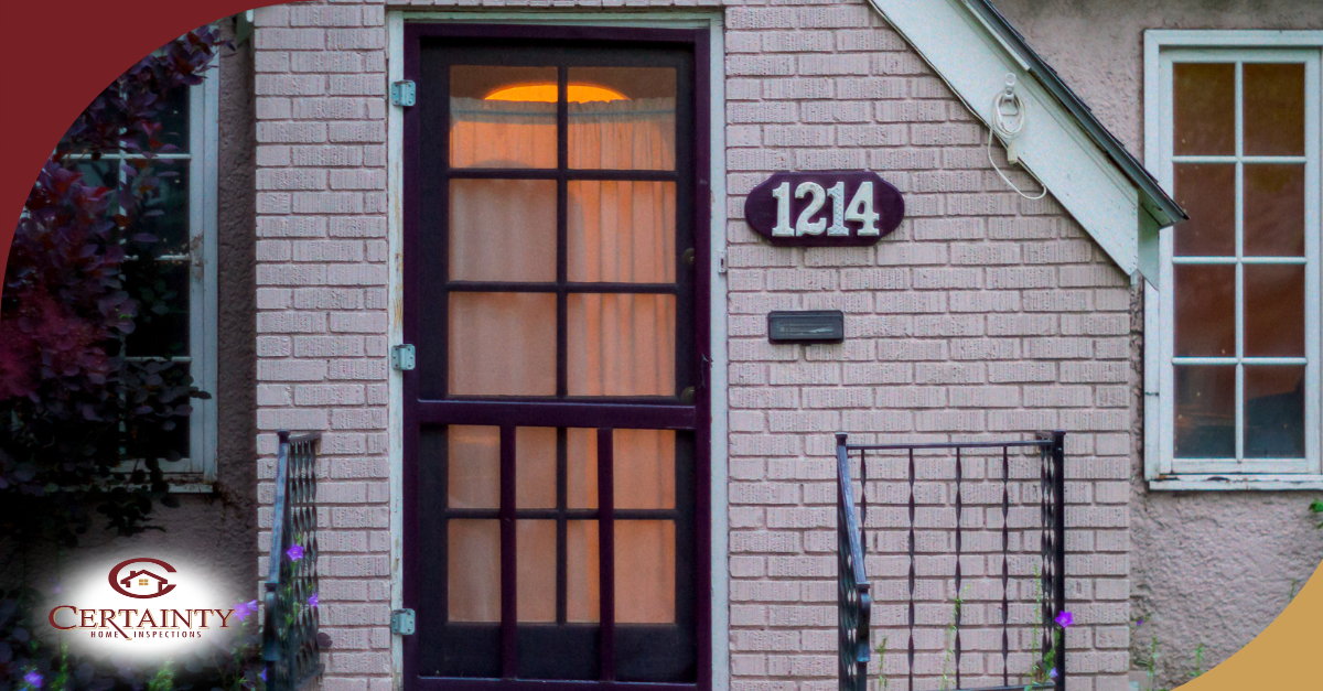 House number 1214 on a plaque above the front door of a brick house