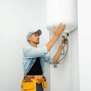 Technician inspecting and adjusting a water heater.