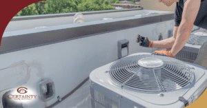 HVAC technician inspecting rooftop air conditioning units on commercial building.