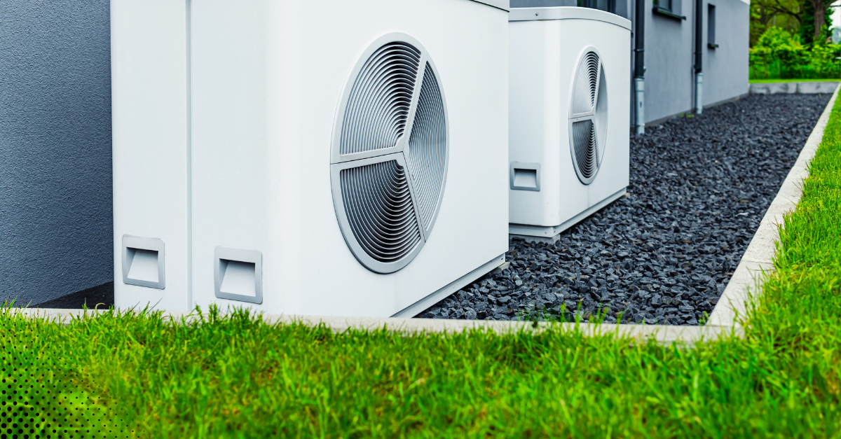 Outdoor HVAC unit installed on gravel beside a modern home.
